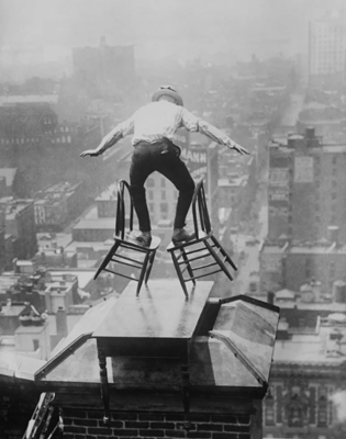 Man balancing on two chairs